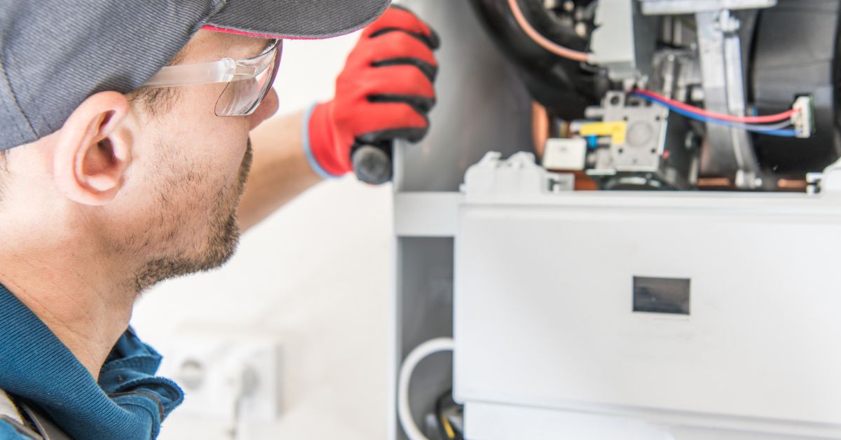 Technician looking at a gas geyser
