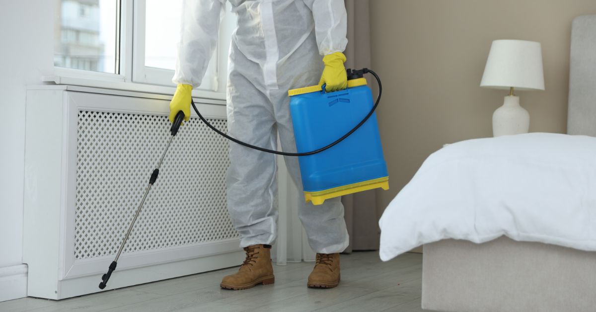 Pest control person spraying a radiator