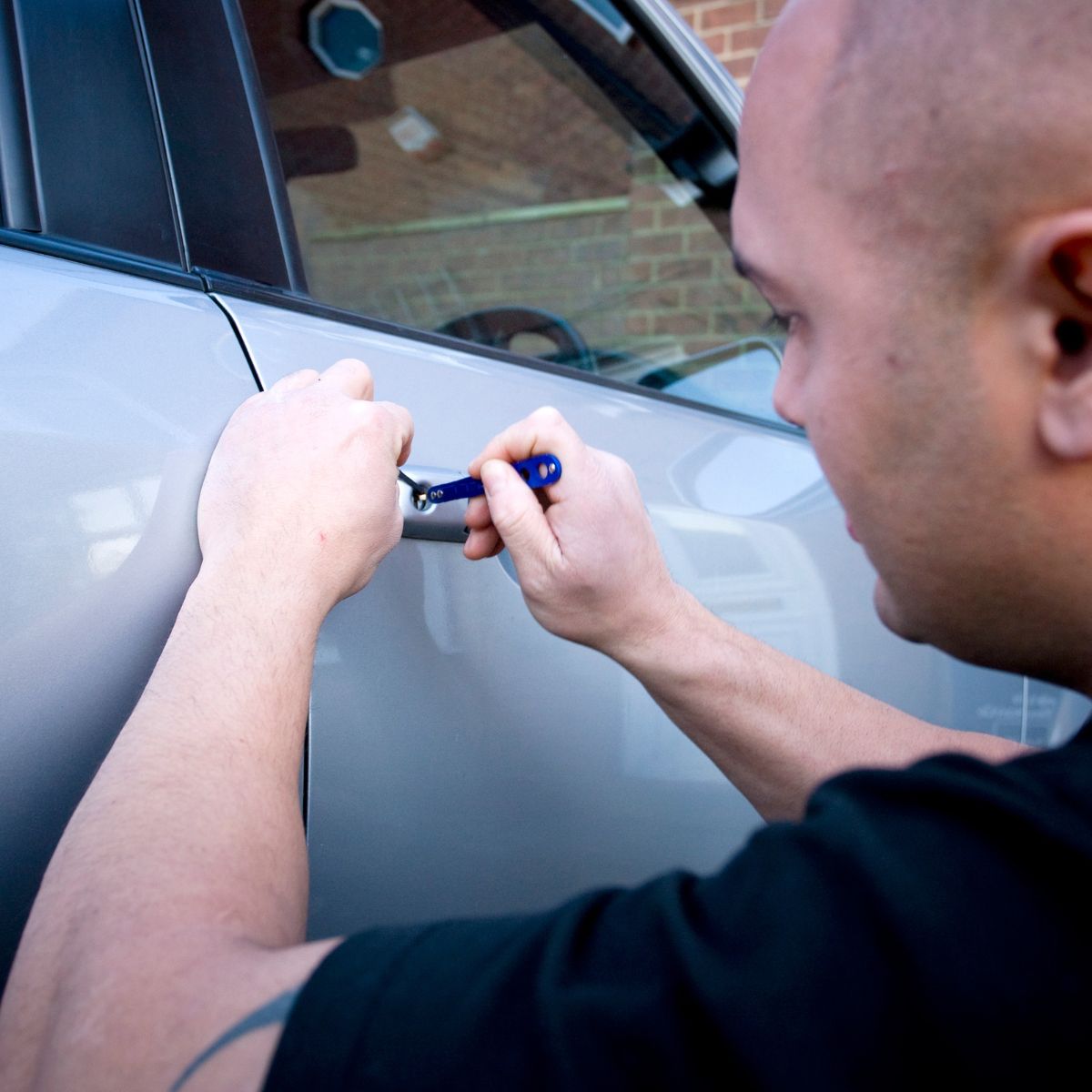 Automotive locksmith cutting a car key